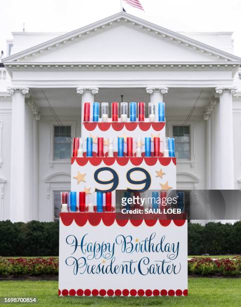Sign wishing a happy birthday to former US President Jimmy Carter sits on the North Lawn of the White House in Washington, DC, September 30 ahead of...