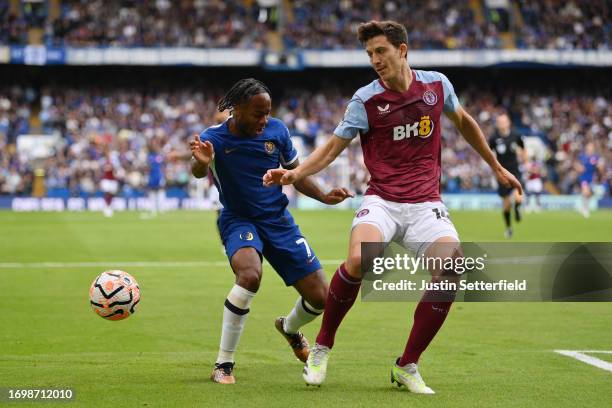 Raheem Sterling of Chelsea battles for possession with Pau Torres of Aston Villa during the Premier League match between Chelsea FC and Aston Villa...