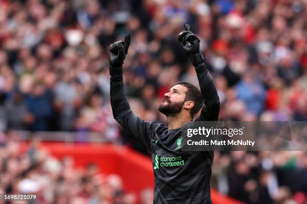 Alisson Becker celebrates after their sides first goal by Mohamed Salah of Liverpool during the Premier League match between Liverpool FC and West...