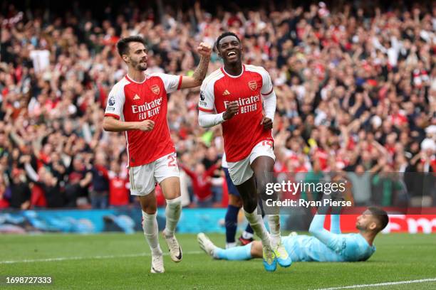 Fabio Vieira and Eddie Nketiah of Arsenal celebrate their sides first goal by Bukayo Saka during the Premier League match between Arsenal FC and...