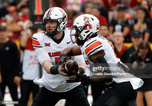 Quarterback Alan Bowman of the Oklahoma State Cowboys hands off the ball to running back Ollie Gordon II of the Oklahoma State Cowboys in the first...