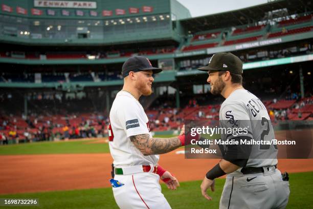 Alex Verdugo of the Boston Red Sox reacts with Andrew Benintendi of the Chicago White Sox before a game on September 23, 2023 at Fenway Park in...