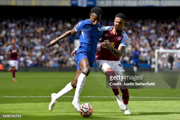 Nicolas Jackson of Chelsea is challenged by Ezri Konsa of Aston Villa during the Premier League match between Chelsea FC and Aston Villa at Stamford...