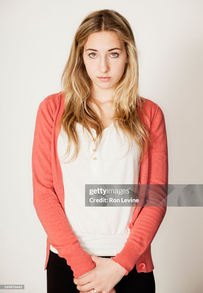 Teen girl clasping hands, portrait