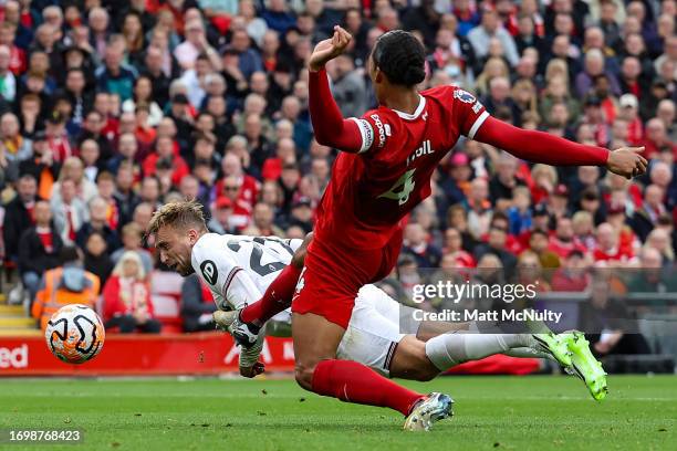 Jarrod Bowen of West Ham United scores the team's first goal under pressure from Virgil van Dijk of Liverpool during the Premier League match between...