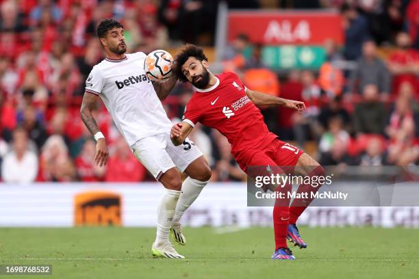 Emerson Palmieri of West Ham United battles for possession with Mohamed Salah of Liverpool during the Premier League match between Liverpool FC and...