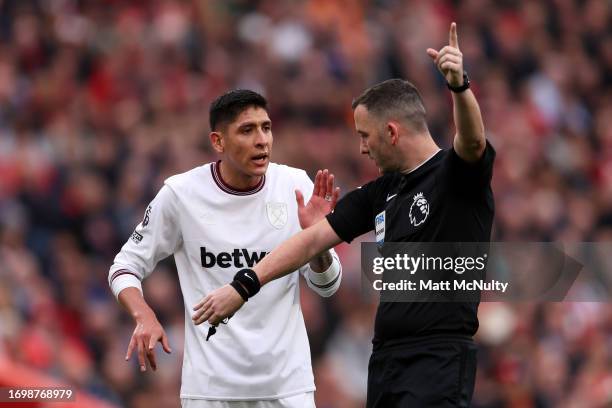 Referee Chris Kavanagh speaks to Edson Alvarez of West Ham United during the Premier League match between Liverpool FC and West Ham United at Anfield...