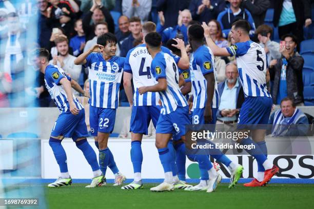 Kaoru Mitoma of Brighton & Hove Albion celebrates with teammates after scoring the team's second goal during the Premier League match between...