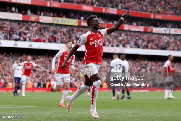 Bukayo Saka of Arsenal celebrates after scoring the team's second goal from the penalty spot during the Premier League match between Arsenal FC and...