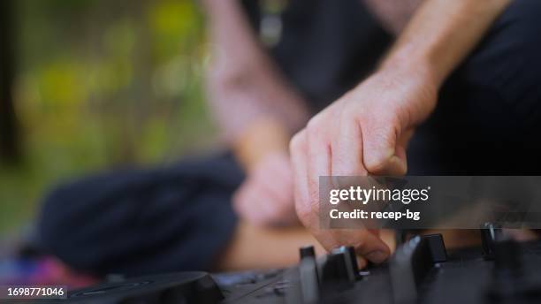 man making music in public park - park man made space stock pictures, royalty-free photos & images