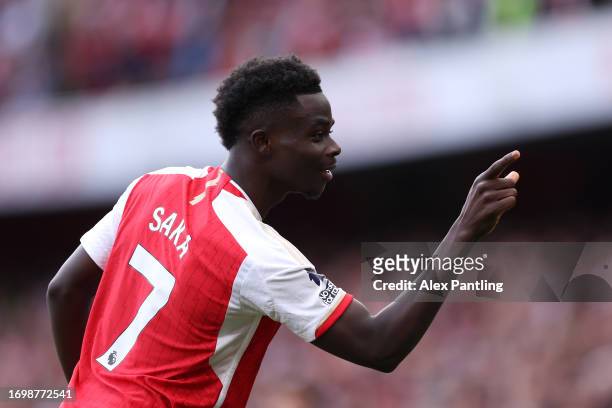 Bukayo Saka of Arsenal celebrates after scoring the team's second goal from the penalty spot during the Premier League match between Arsenal FC and...