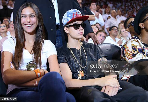 Singer Justin Bieber sits courtside as he watches the Miami Heat host the Indiana Pacers during Game Seven of the Eastern Conference Finals of the...