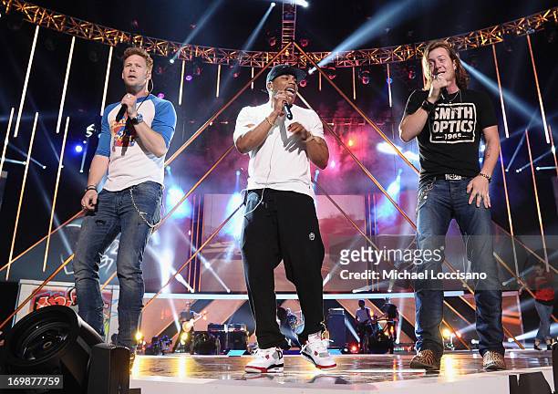 Nelly performs onstage with Brian Kelley and Tyler Hubbard of Florida Georgia Line during the 2013 CMT Music Awards Rehearsals Day 1 at Bridgestone...