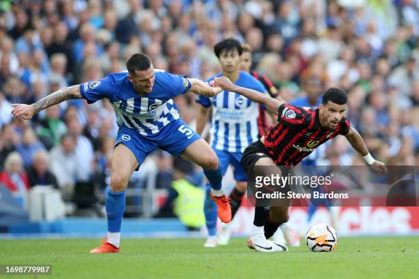 Dominic Solanke of AFC Bournemouth is challenged by Lewis Dunk of Brighton & Hove Albion during the Premier League match between Brighton & Hove...