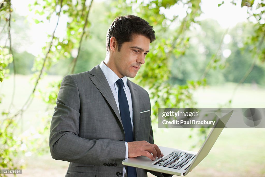 Businessman using laptop outdoors