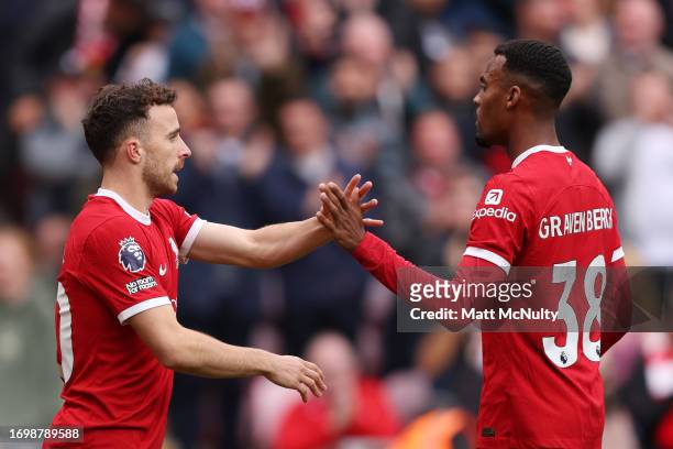 Diogo Jota celebrates with Ryan Gravenberch of Liverpool after scoring the team's third goal during the Premier League match between Liverpool FC and...