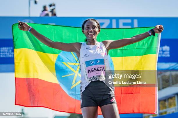 Tigist Assefa from Ethiopia celebrating after crossing the finish line and set a new world record of 2:11:53h during the 2023 BMW Berlin-Marathon on...