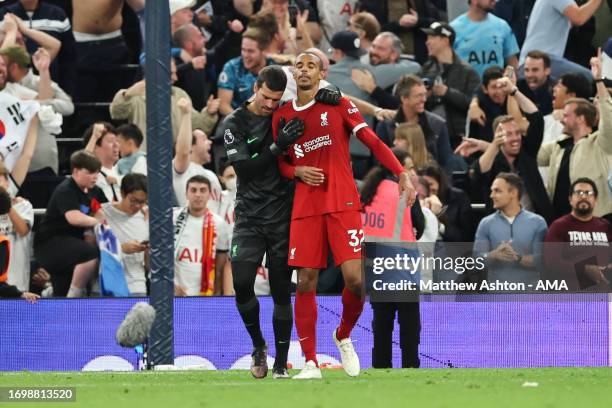 Alisson Becker consoles Joel Matip of Liverpool after he scored an own goal in the 96th minute to make it 2-1during the Premier League match between...
