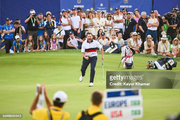 Patrick Cantlay of the U.S. Team celebrates with a fist pump after making a birdie putt on the 18th hole green during Saturday afternoon four-ball...
