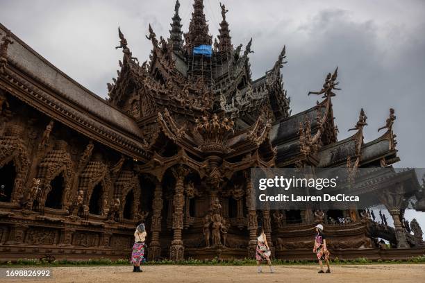 Foreign tourists walk through The Sanctuary of Truth Museum on September 24, 2023 in Pattaya, Thailand. Starting on September 25, tourists from China...