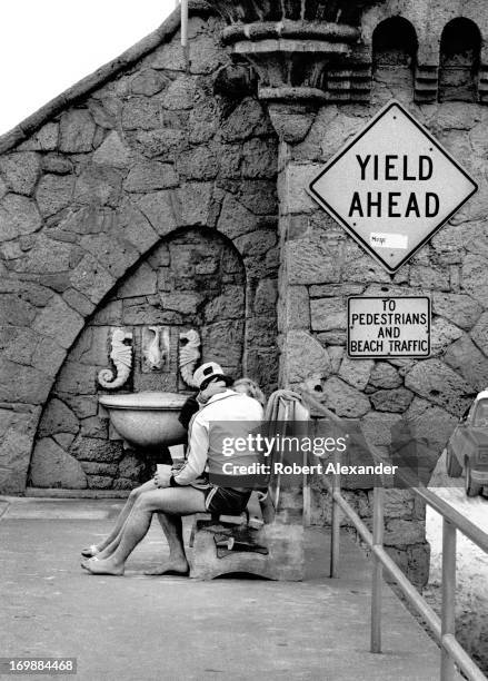 Young couple kiss on a bench beside the landmark Boardwalk at Daytona Beach, Florida. 5104602RA_Florida158.jpg