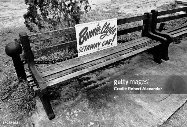 Sign on a bench at the Tragedy in U.S. History Museum in St. Augustine, Florida, advertises the museum's 'Bonnie & Clyde Getaway Car.' Before it...