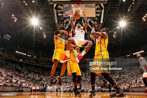 LeBron James of the Miami Heat dunks against David West, Paul George and Roy Hibbert of the Indiana Pacers in Game Seven of the Eastern Conference...