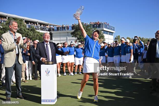 Team Europe captain Suzann Pettersen celebrates with the Solheim Cup after her teams win during Day Three of The Solheim Cup at Finca Cortesin Golf...