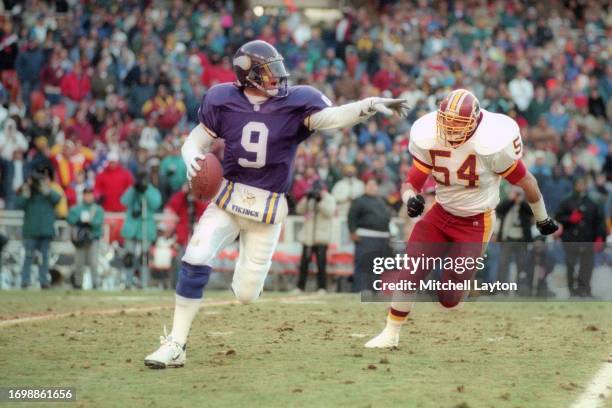 Jim McMahon of the Minnesota Vikings looks to throw a pass during a NFL football game against the Washington Redskins on December 31, 1993 at RFK...