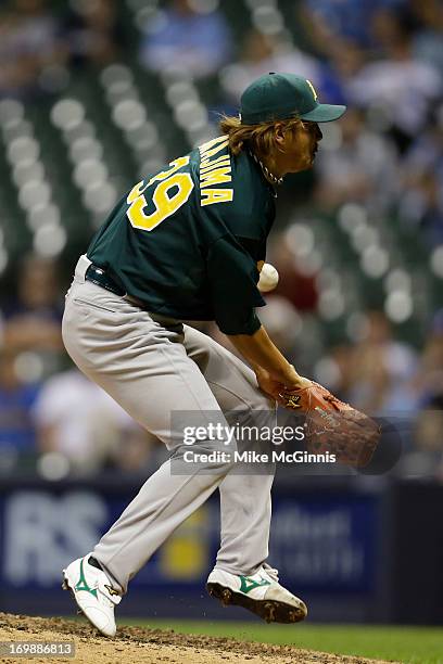 Hideki Okajima of the Oakland Athletics gets hit by a this ball from Ryan Braun of the Milwaukee Brewers in the bottom of the eighth inning during...