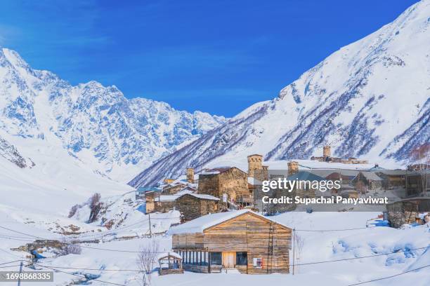 ushguli village in winter season with snow in sunny day - snow day stock pictures, royalty-free photos & images
