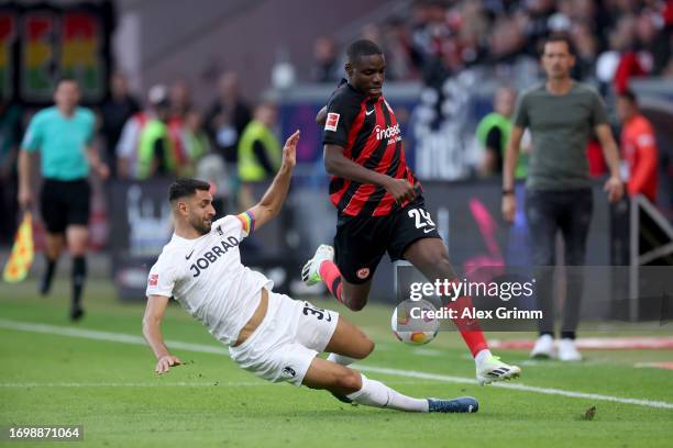 Niels Nkounkou of Eintracht Frankfurt is challenged by Vincenzo Grifo of Sport-Club Freiburg during the Bundesliga match between Eintracht Frankfurt...