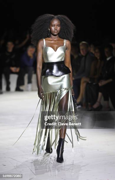 Model Adut Akech walks the runway at the Alexander McQueen SS24 show during Paris Fashion Week at Le Carreau du Temple on September 30, 2023 in...