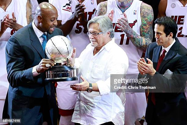 Former Miami Heat player Alonzo Mourning presents the Eastern Conference Championship trophy to team owner Micky Arison adn head coach Erik Spoelstra...