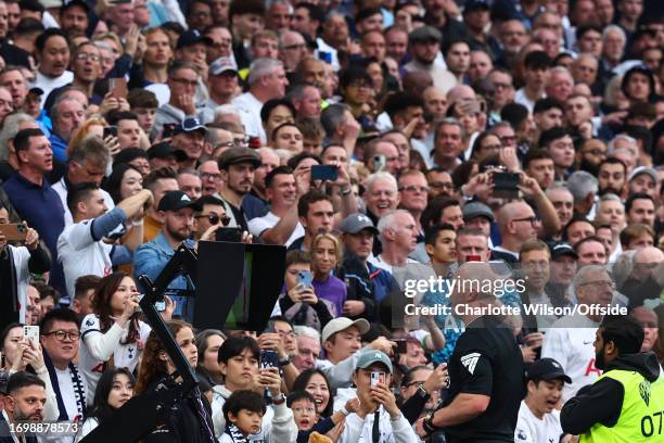 Referee Simon Hooper consults VAR during the Premier League match between Tottenham Hotspur and Liverpool FC at Tottenham Hotspur Stadium on...