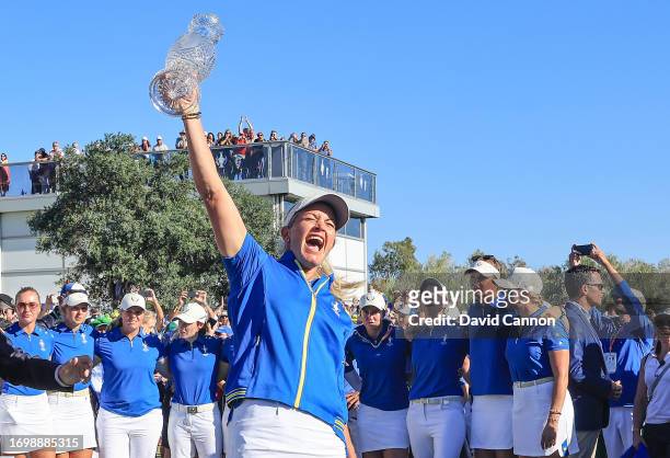 Suzann Pettersen of Norway the Captain of The European Team lifts the Solheim after Europe had retained the cup during the final day singles matches...