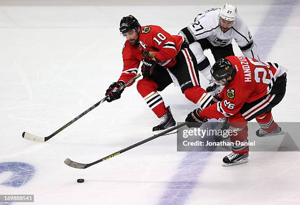 Michal Handzus of the Chicago Blackhawks controls the puck over the Kings blueline on the two on one with teammate Patrick Sharp against Alec...