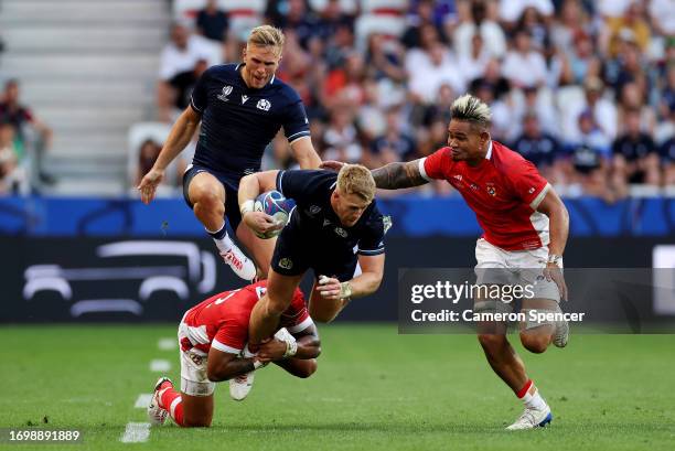 Kyle Steyn of Scotland is tackled by Pita Ahki and Vaea Fifita of Tonga during the Rugby World Cup France 2023 match between Scotland and Tonga at...