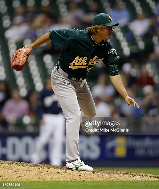 Hideki Okajima of the Oakland Athletics pitches in the bottom of the eighth inning against the Milwaukee Brewers during the interleague game at...