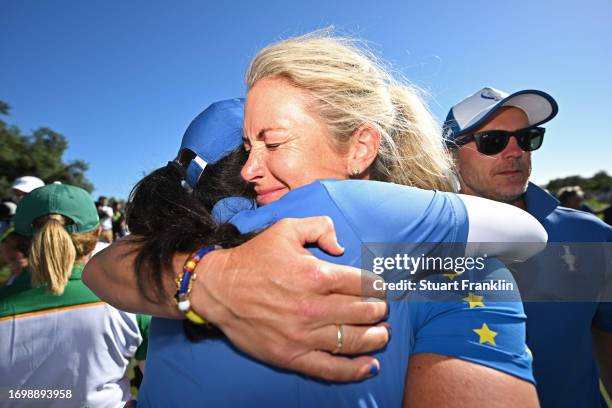 Carlota Ciganda and captain Suzann Pettersen of Team Europe celebrate their team's win against Team USA during Day Three of The Solheim Cup at Finca...