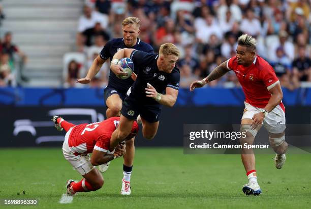 Kyle Steyn of Scotland is tackled by Pita Ahki and Vaea Fifita of Tonga during the Rugby World Cup France 2023 match between Scotland and Tonga at...