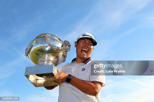 Ryo Hisatsune of Japan celebrates with the trophy after winning on Day Four of the Cazoo Open de France at Le Golf National on September 24, 2023 in...