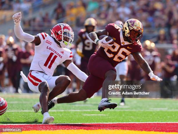 Zach Evans of the Minnesota Golden Gophers scores a touchdown in the fourth quarter against Caleb Anderson of the Louisiana-Lafayette Ragin Cajuns at...