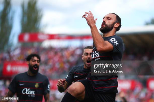 Vedat Muriqi of RCD Mallorca celebrates with his teammates after scoring the team's first goal during the LaLiga EA Sports match between Girona FC...