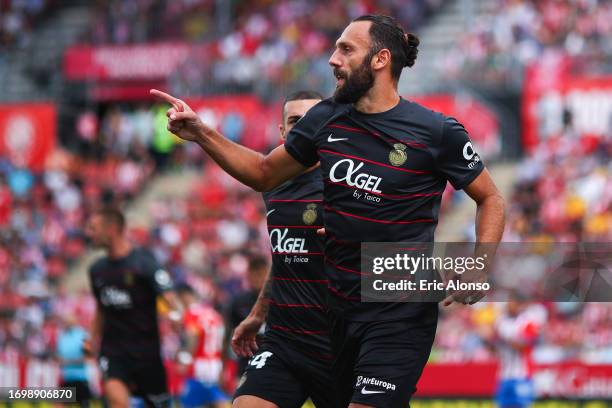 Vedat Muriqi of RCD Mallorca celebrates with his teammates after scoring the team's first goal during the LaLiga EA Sports match between Girona FC...