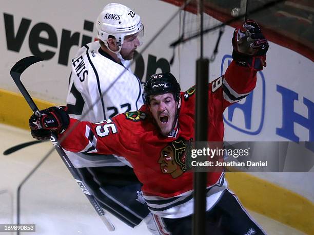 Andrew Shaw of the Chicago Blackhawks celebrates his goal in the first period of Game Two of the Western Conference Final as Trevor Lewis of the Los...