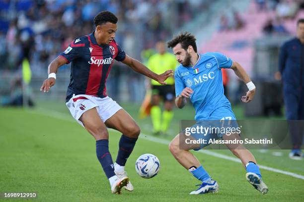 Dan Ndoye of Bologna and Khvicha Kvaratskhelia of Napoli battle for possession during the Serie A TIM match between Bologna FC and SSC Napoli at...