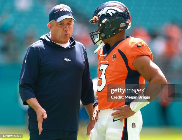Head coach Sean Payton of the Denver Broncos talks to Russell Wilson of the Denver Broncos prior to a game against the Miami Dolphins at Hard Rock...
