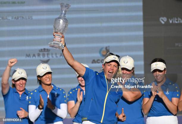 Team Europe captain Suzann Pettersen celebrates with the Solheim Cup after her teams win during Day Three of The Solheim Cup at Finca Cortesin Golf...