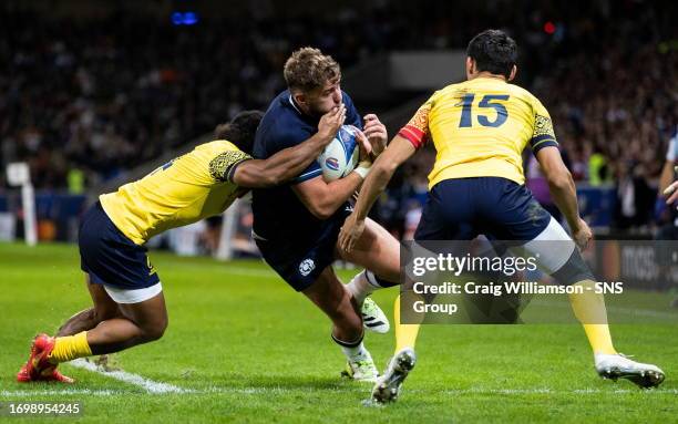 Scotland's Ollie Smith is tackled by Romania's Marius Simionescu during a Rugby World Cup match between Scotland and Romania at the Stade Pierre...